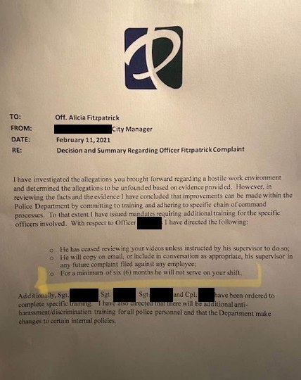 Phone photo of the city manager’s memo to Officer Fitzpatrick, February 11, 2021, with names blacked out. A highlighter line marks one officer’s orders.